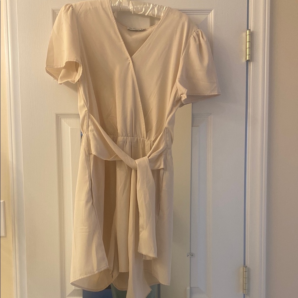 Cream Wrap Tie Front Romper with Puff Sleeves and pockets.